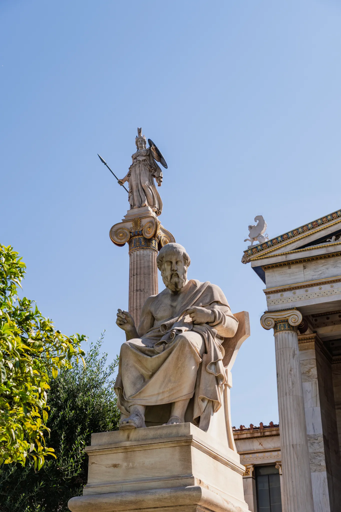 The Academy of Athens: a seated marble Plato below the column-top statue of Athena