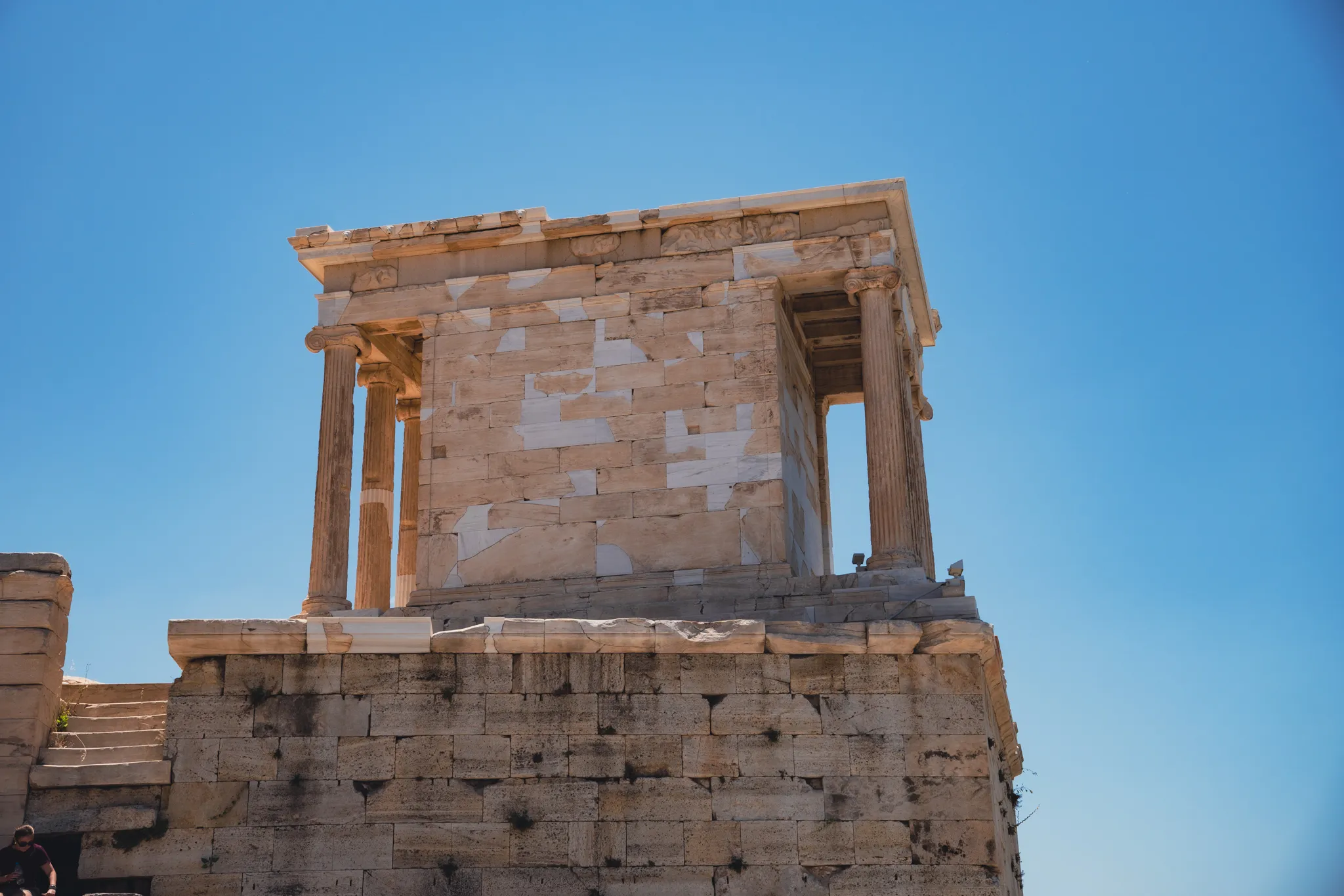 The Temple of Athena Nike on its bastion at the Acropolis against a cloudless sky
